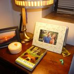 Nell Casey's nightstand: "Lamp with my college gradation tassels (golden with honors! #humblebrag), two framed photos—one taken by my boyfriend's mom of the sunrise at the Verrazano, the other of me and my boyfriend a few years ago. Hand lotion, a few books, condoms, vibrator, bobby pins, ear plugs for the street noise, softball bat for crackhead intruders."